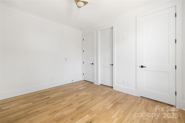 554 W Cama St, Charlotte, NC 28217 - unfurnished bedroom with light wood-style flooring, baseboards, ornamental molding, and a ceiling fan