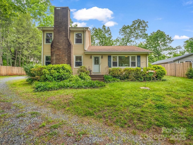 125 Snug Harbor Cir, Lake Lure, NC 28746 - view of front of home with a front lawn, fence, and a chimney