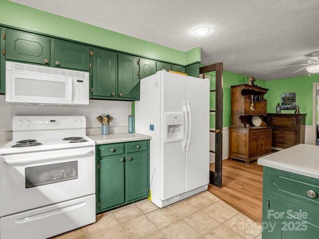 125 Snug Harbor Cir, Lake Lure, NC 28746 - kitchen with ceiling fan, a textured ceiling, white appliances, and light countertops