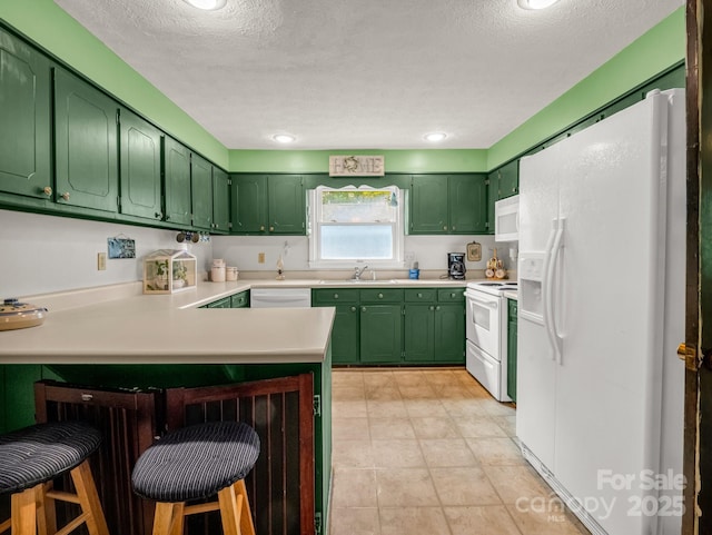 125 Snug Harbor Cir, Lake Lure, NC 28746 - kitchen with a sink, a peninsula, white appliances, and green cabinetry