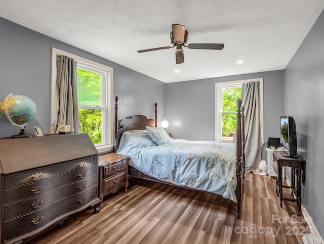 125 Snug Harbor Cir, Lake Lure, NC 28746 - bedroom with a textured ceiling, wood finished floors, and ceiling fan