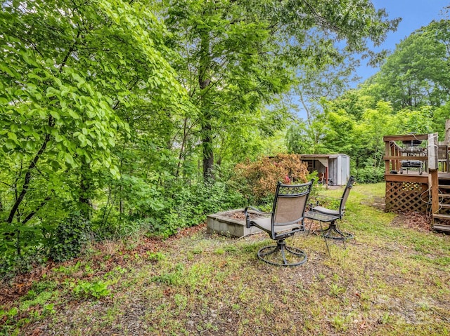 125 Snug Harbor Cir, Lake Lure, NC 28746 - view of yard with an outdoor structure, a wooden deck, and a storage shed