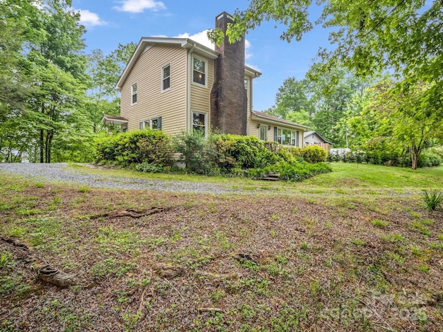 125 Snug Harbor Cir, Lake Lure, NC 28746 - view of side of home featuring a chimney and a lawn