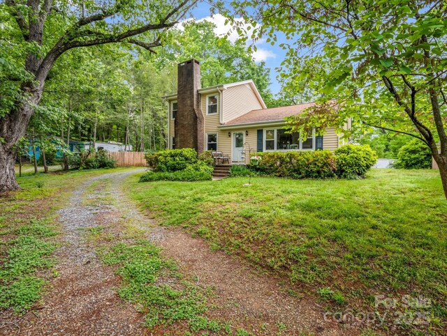 125 Snug Harbor Cir, Lake Lure, NC 28746 - exterior space with a chimney, a front yard, and fence
