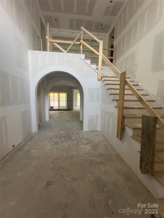 3030 Brookridge Ln, Charlotte, NC 28211 - hall featuring arched walkways, a high ceiling, and stairway
