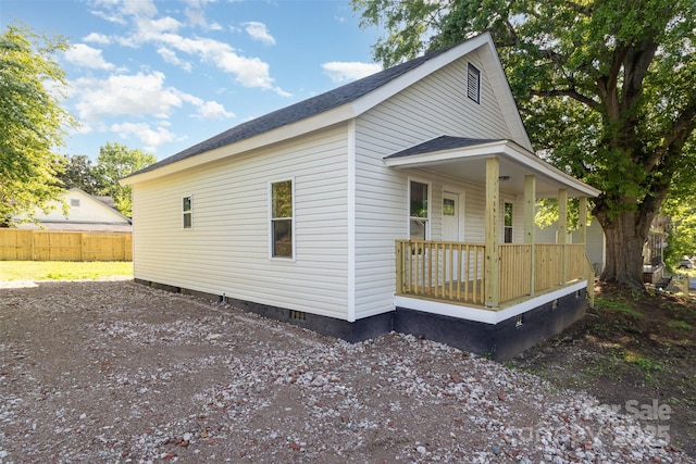 555 Pryor St, Chester, SC 29706 - view of side of property featuring fence, covered porch, a shingled roof, and crawl space