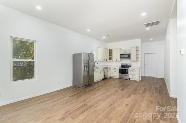 555 Pryor St, Chester, SC 29706 - kitchen featuring open shelves, light countertops, light wood-style flooring, stainless steel appliances, and visible vents