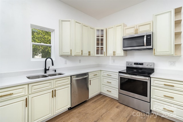 555 Pryor St, Chester, SC 29706 - kitchen with open shelves, a sink, light countertops, stainless steel appliances, and cream cabinetry