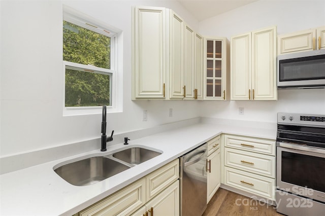 555 Pryor St, Chester, SC 29706 - kitchen with light countertops, a sink, cream cabinets, and stainless steel appliances