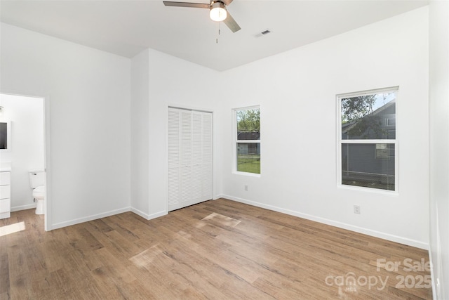 555 Pryor St, Chester, SC 29706 - unfurnished bedroom featuring visible vents, baseboards, wood finished floors, and multiple windows