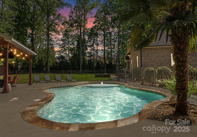 860 Arrow Point Ln, Davidson, NC 28036 - pool at dusk featuring a patio, fence, and a fenced in pool