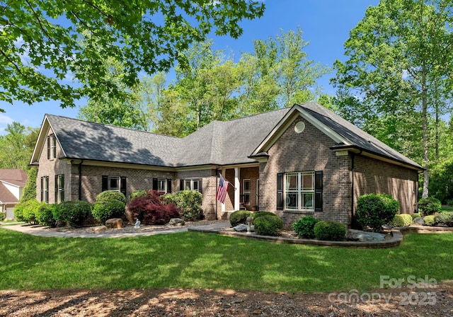 860 Arrow Point Ln, Davidson, NC 28036 - view of front of home with a shingled roof, brick siding, and a front lawn