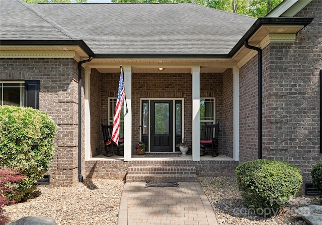 860 Arrow Point Ln, Davidson, NC 28036 - entrance to property featuring covered porch, brick siding, and roof with shingles