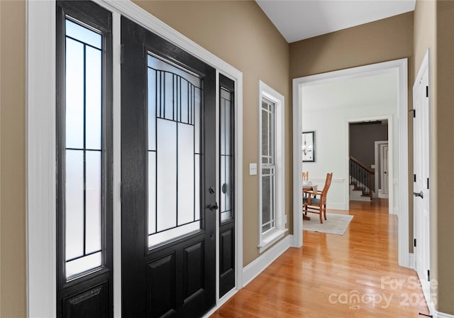 860 Arrow Point Ln, Davidson, NC 28036 - entryway with baseboards, a healthy amount of sunlight, stairs, and light wood-style flooring