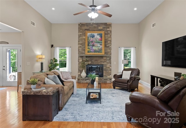 860 Arrow Point Ln, Davidson, NC 28036 - living room with visible vents, plenty of natural light, light wood finished floors, and a towering ceiling