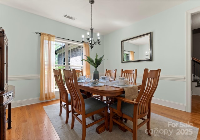 860 Arrow Point Ln, Davidson, NC 28036 - dining room with a notable chandelier, light wood finished floors, visible vents, and baseboards