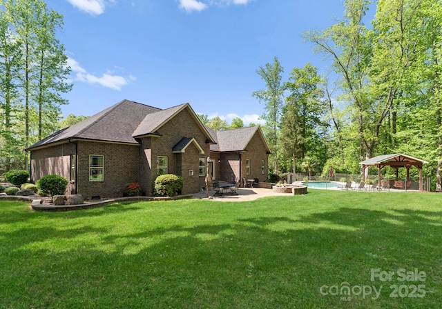 860 Arrow Point Ln, Davidson, NC 28036 - rear view of property featuring a yard, a gazebo, a patio area, and brick siding