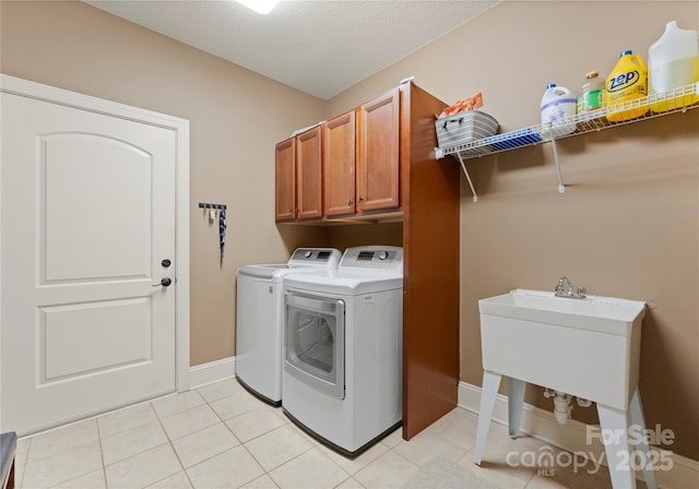 860 Arrow Point Ln, Davidson, NC 28036 - clothes washing area with light tile patterned flooring, cabinet space, washing machine and clothes dryer, and baseboards