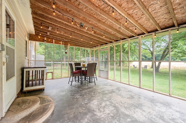 sunroom / solarium featuring outdoor dining space
