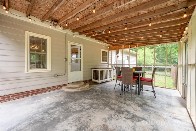 sunroom featuring outdoor dining area