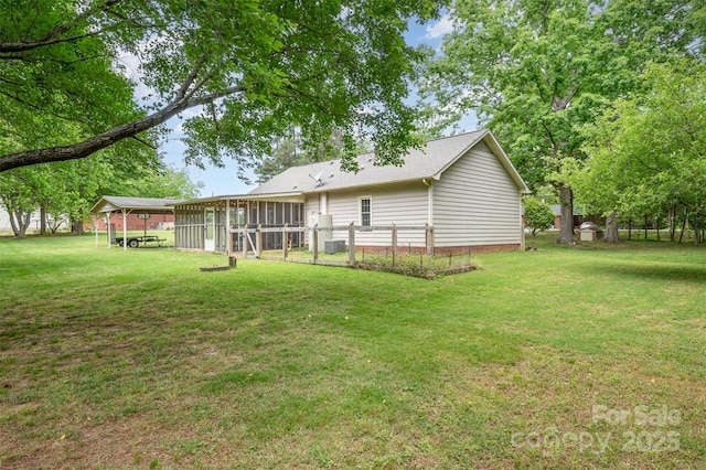 back of property featuring a yard and a sunroom