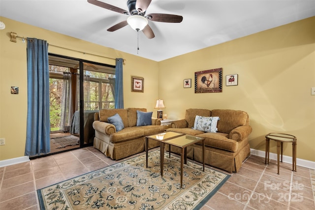 tiled living area with baseboards and a ceiling fan