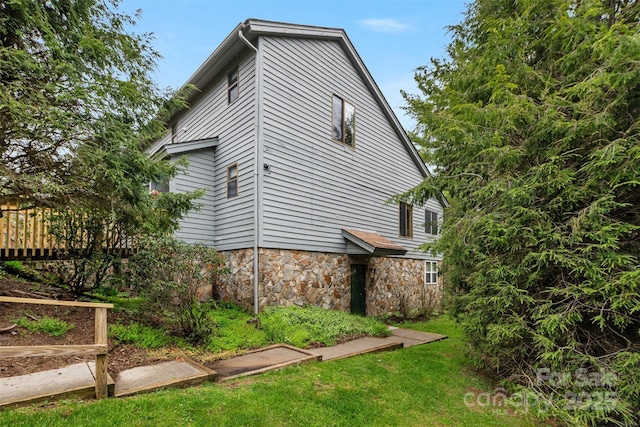 view of home's exterior with a lawn
