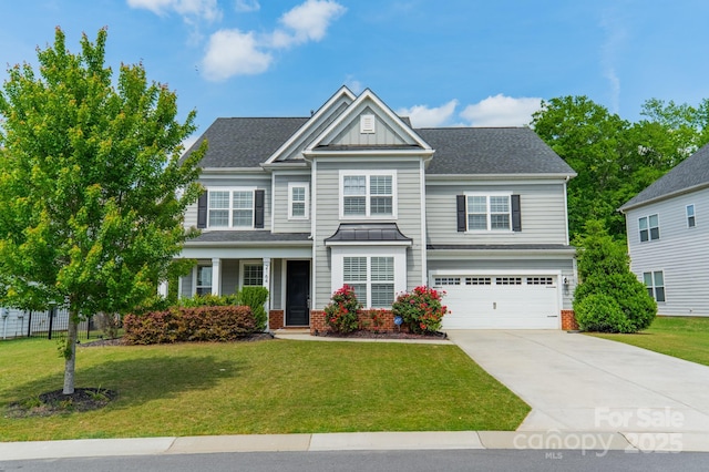 craftsman-style home with a garage, board and batten siding, driveway, and a front yard