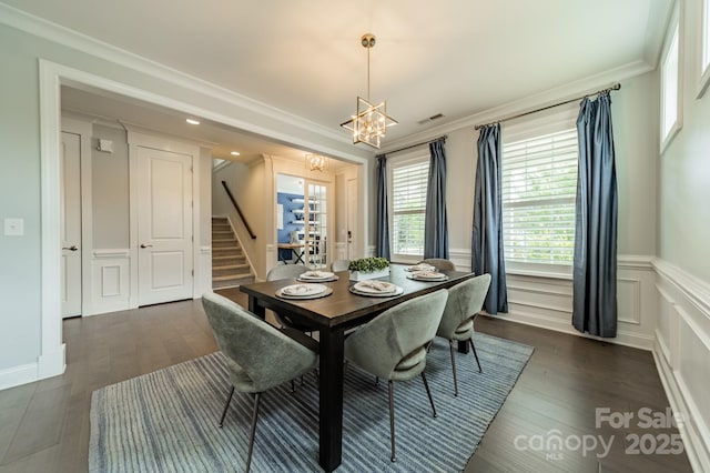 dining room featuring visible vents, stairs, wainscoting, dark wood-type flooring, and a notable chandelier