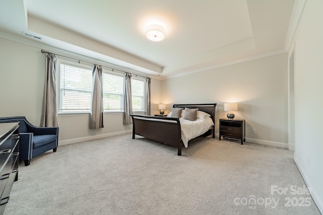 bedroom with a tray ceiling, visible vents, baseboards, and carpet