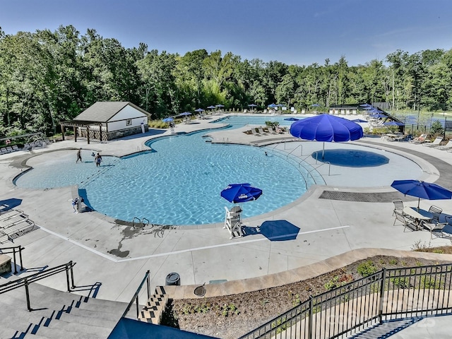 pool featuring a patio area and fence