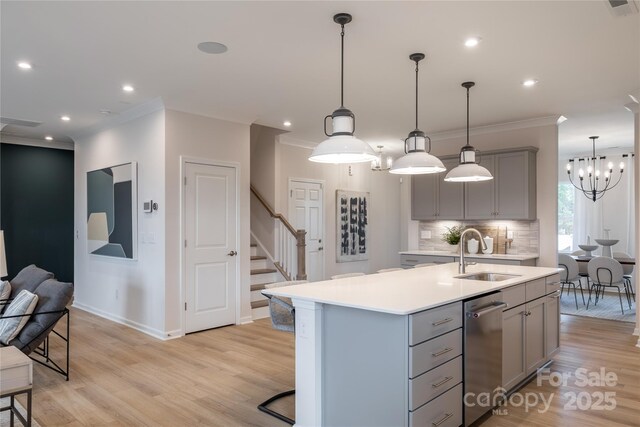 12017 Grinstead Ln Unit 301, Charlotte, NC 28278 - kitchen featuring gray cabinets, a sink, light countertops, crown molding, and light wood-type flooring