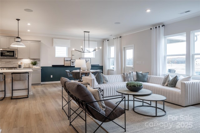 12017 Grinstead Ln Unit 301, Charlotte, NC 28278 - living room featuring light wood-type flooring, a chandelier, recessed lighting, and crown molding