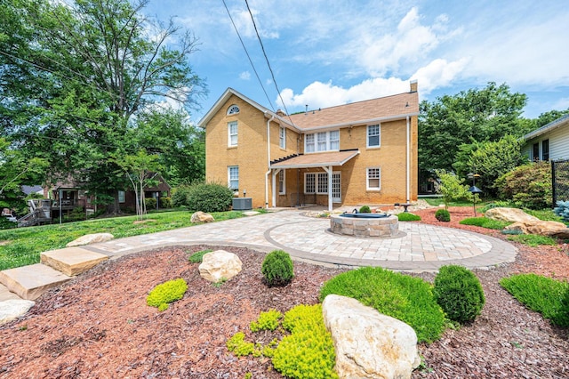 625 2nd St NE, Hickory, NC 28601 - rear view of property with a fire pit, a patio area, a chimney, central AC unit, and brick siding