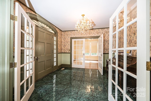 625 2nd St NE, Hickory, NC 28601 - foyer entrance featuring french doors, wallpapered walls, baseboards, wainscoting, and a chandelier