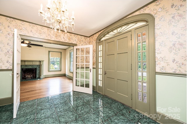 625 2nd St NE, Hickory, NC 28601 - foyer featuring wallpapered walls, a chandelier, a high end fireplace, ceiling fan, and tile patterned flooring