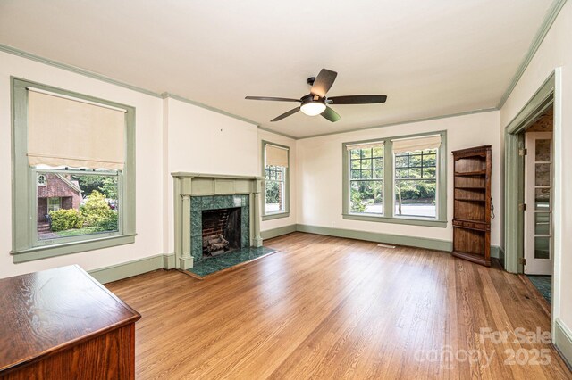 625 2nd St NE, Hickory, NC 28601 - unfurnished living room featuring wood finished floors, a high end fireplace, a ceiling fan, ornamental molding, and baseboards