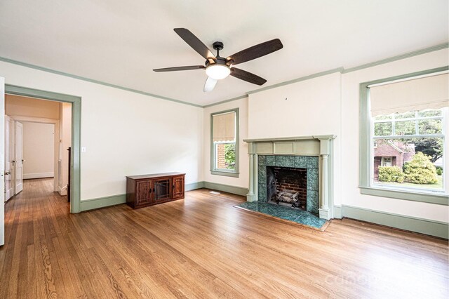 625 2nd St NE, Hickory, NC 28601 - unfurnished living room with crown molding, wood finished floors, ceiling fan, baseboards, and a fireplace