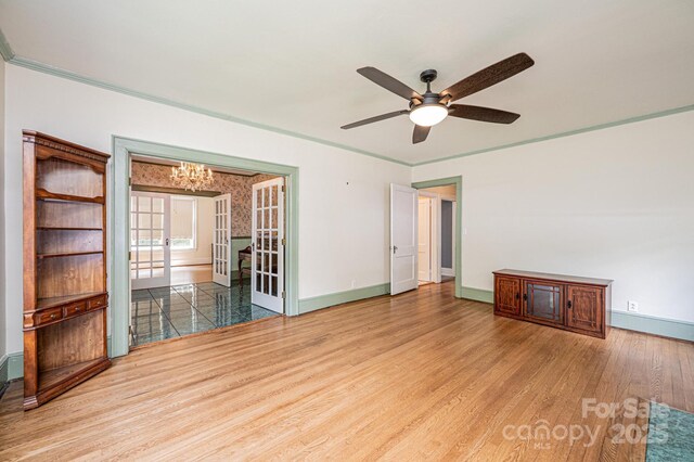 625 2nd St NE, Hickory, NC 28601 - spare room featuring baseboards, wood finished floors, a chandelier, ceiling fan, and ornamental molding
