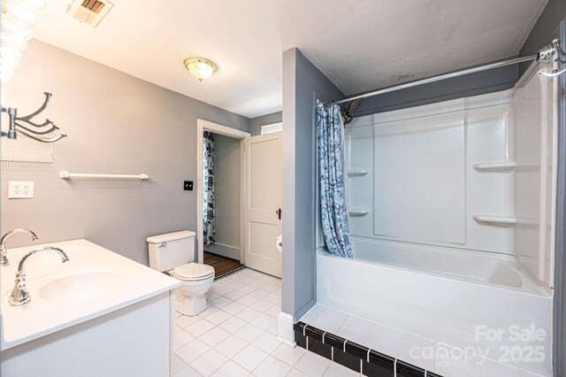 625 2nd St NE, Hickory, NC 28601 - bathroom with tile patterned floors, toilet, vanity, shower / tub combo with curtain, and baseboards