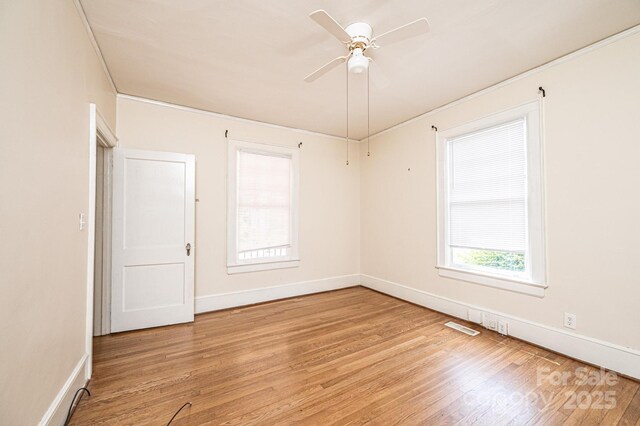 625 2nd St NE, Hickory, NC 28601 - empty room featuring light wood-style floors, a ceiling fan, baseboards, and crown molding