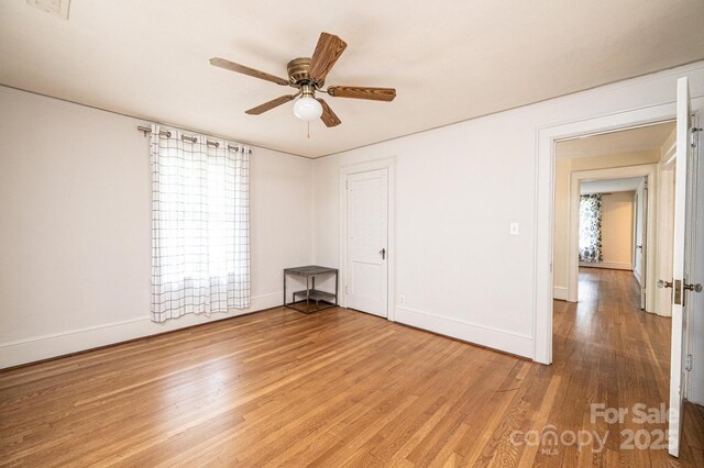 625 2nd St NE, Hickory, NC 28601 - unfurnished room with light wood finished floors, a ceiling fan, and baseboards