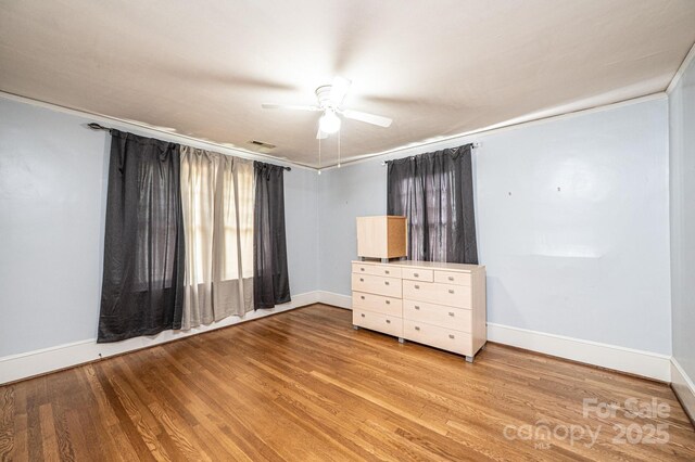 625 2nd St NE, Hickory, NC 28601 - empty room featuring ceiling fan, baseboards, light wood-style floors, and crown molding
