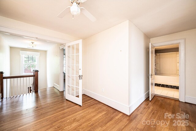 625 2nd St NE, Hickory, NC 28601 - spare room featuring wood finished floors, baseboards, french doors, and ceiling fan