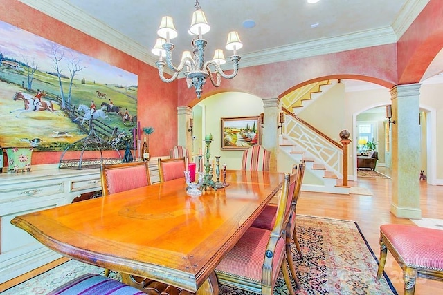 3400 Baucom Manor Rd, Monroe, NC 28110 - dining area featuring decorative columns, arched walkways, wood finished floors, a chandelier, and stairway