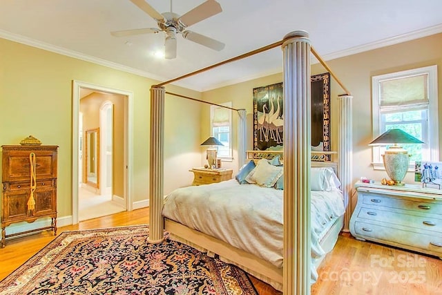 3400 Baucom Manor Rd, Monroe, NC 28110 - bedroom featuring multiple windows, wood finished floors, crown molding, a ceiling fan, and baseboards