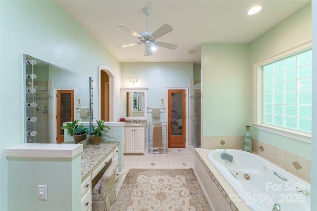 3400 Baucom Manor Rd, Monroe, NC 28110 - full bath with a shower stall, vanity, a whirlpool tub, a ceiling fan, and tile patterned flooring