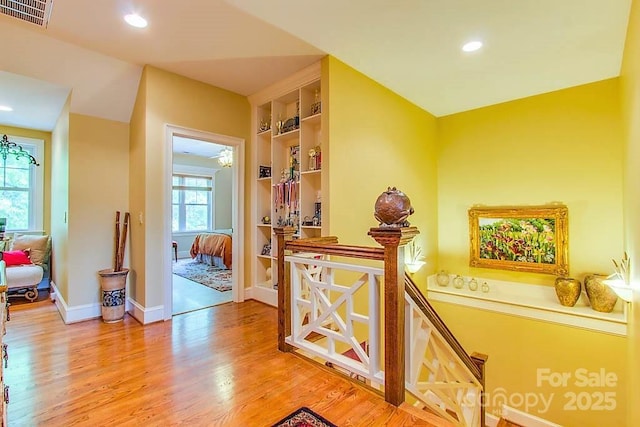 3400 Baucom Manor Rd, Monroe, NC 28110 - hall with light wood finished floors, built in features, recessed lighting, and baseboards