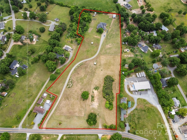 aerial view of property and surrounding area with property parcel outlined