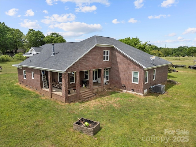 back of property with crawl space, brick siding, central AC, a lawn, and a shingled roof